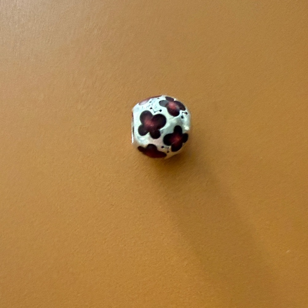 This item is a retired Pandora sterling silver and red enamel butterfly